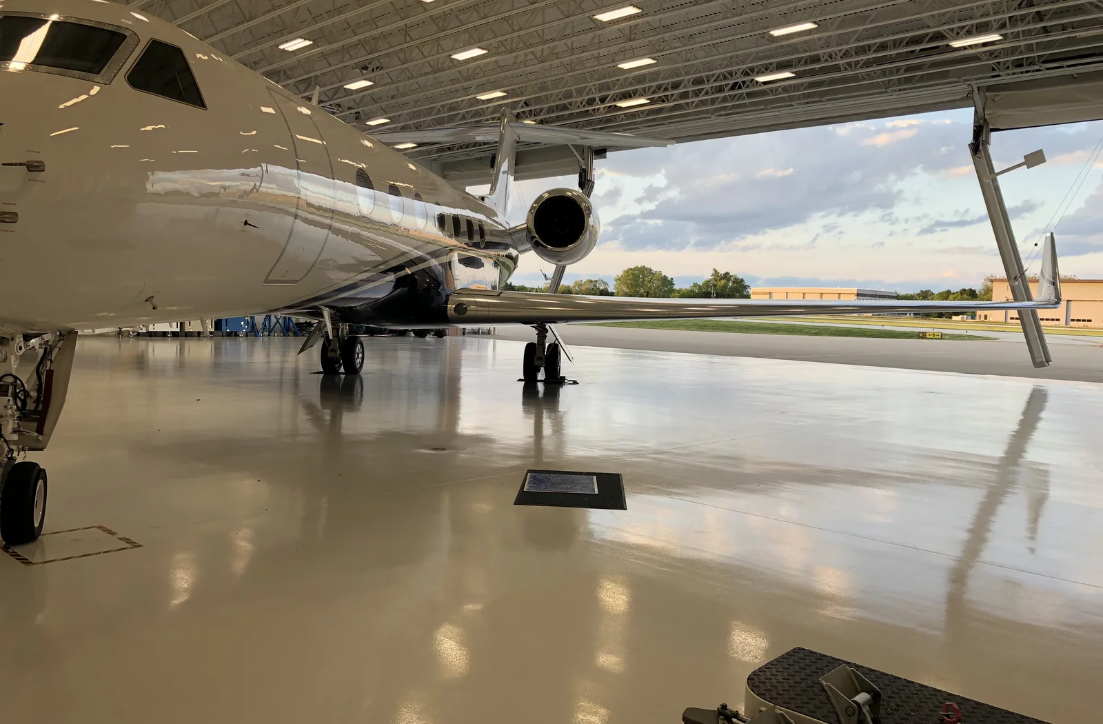 Private jet parked inside a clean, open aircraft hangar